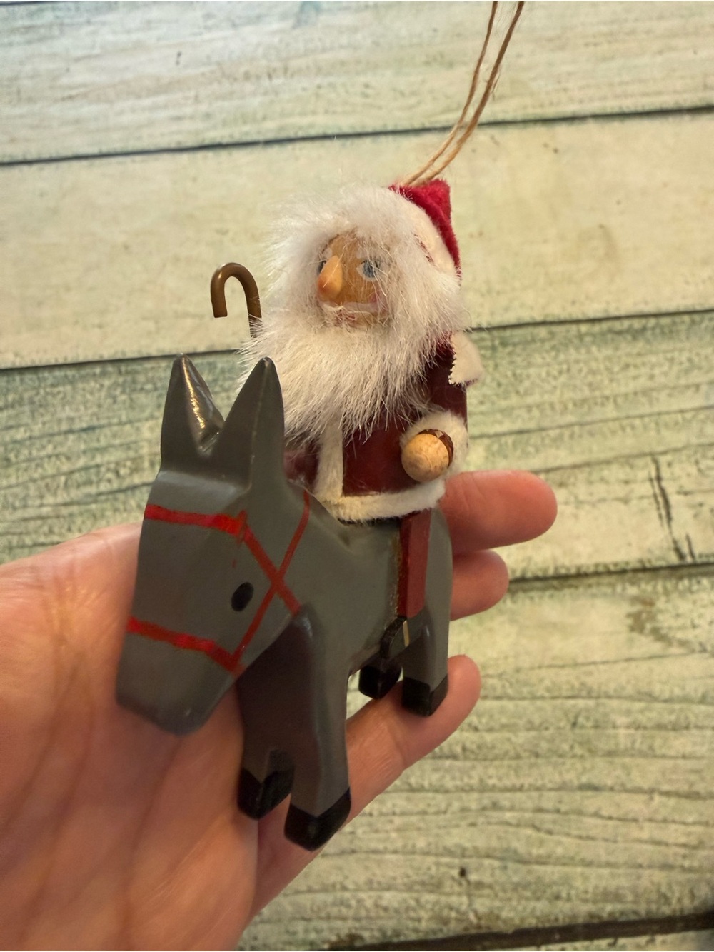 Vintage Christmas wood Santa riding a donkey horse ornament.